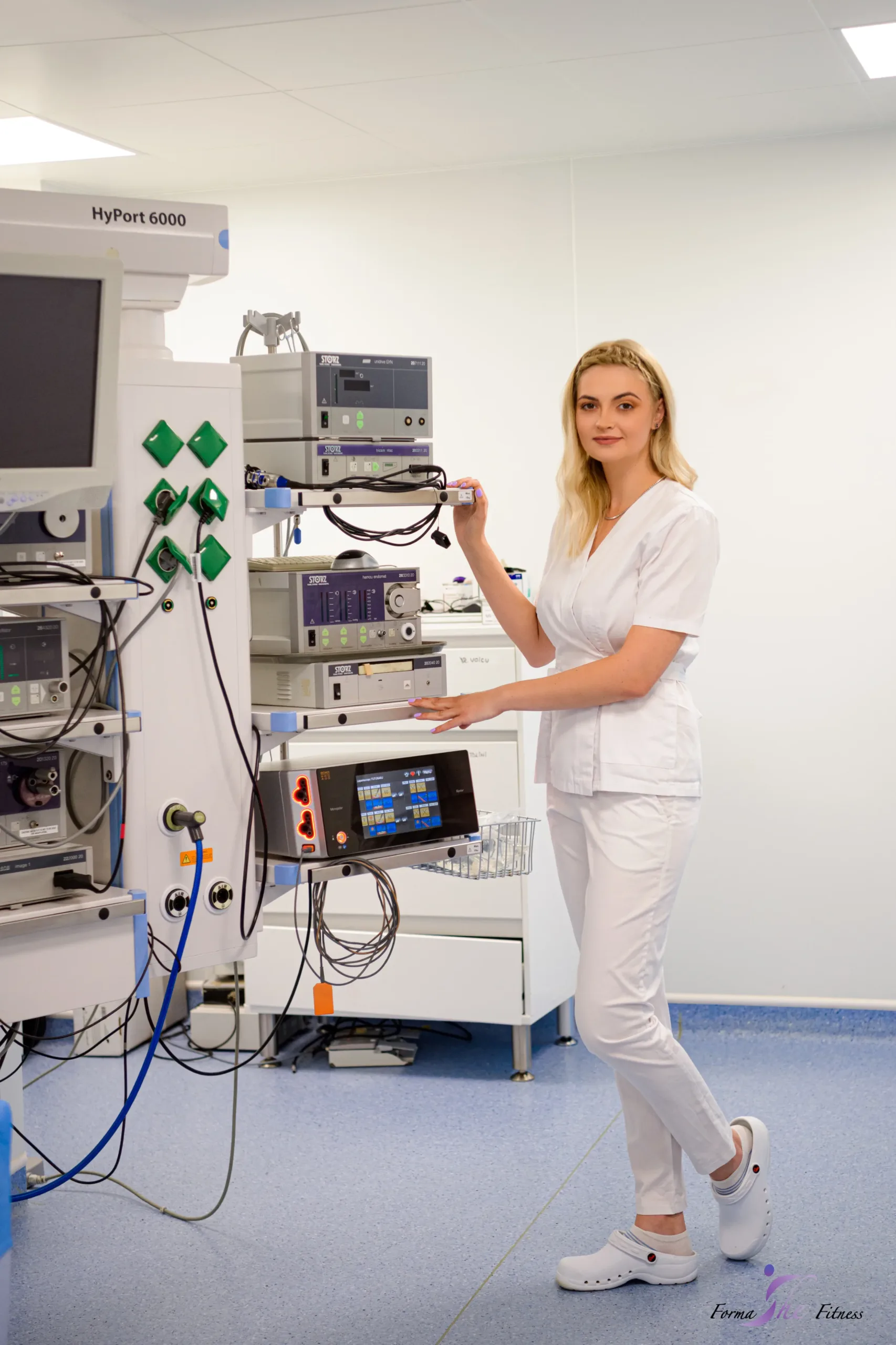 Doctor Oana Calo in sala de operatii, cu mana pe un aparat